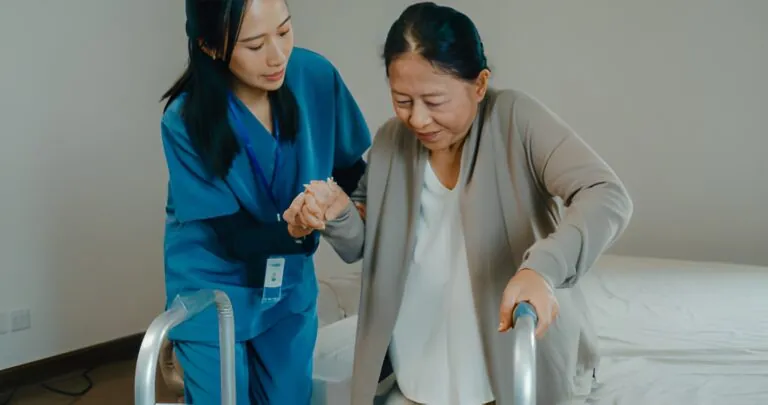 A female therapist performs a focused, manual therapy technique or adjustment on a female patient's lower back while she lies on her side on a treatment table, illustrating expert Physical Therapy Port St Lucie care.