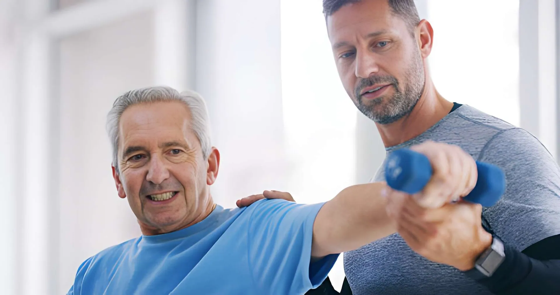 Chiropractor Fort Pierce assisting senior patient with guided arm exercise during rehabilitation session