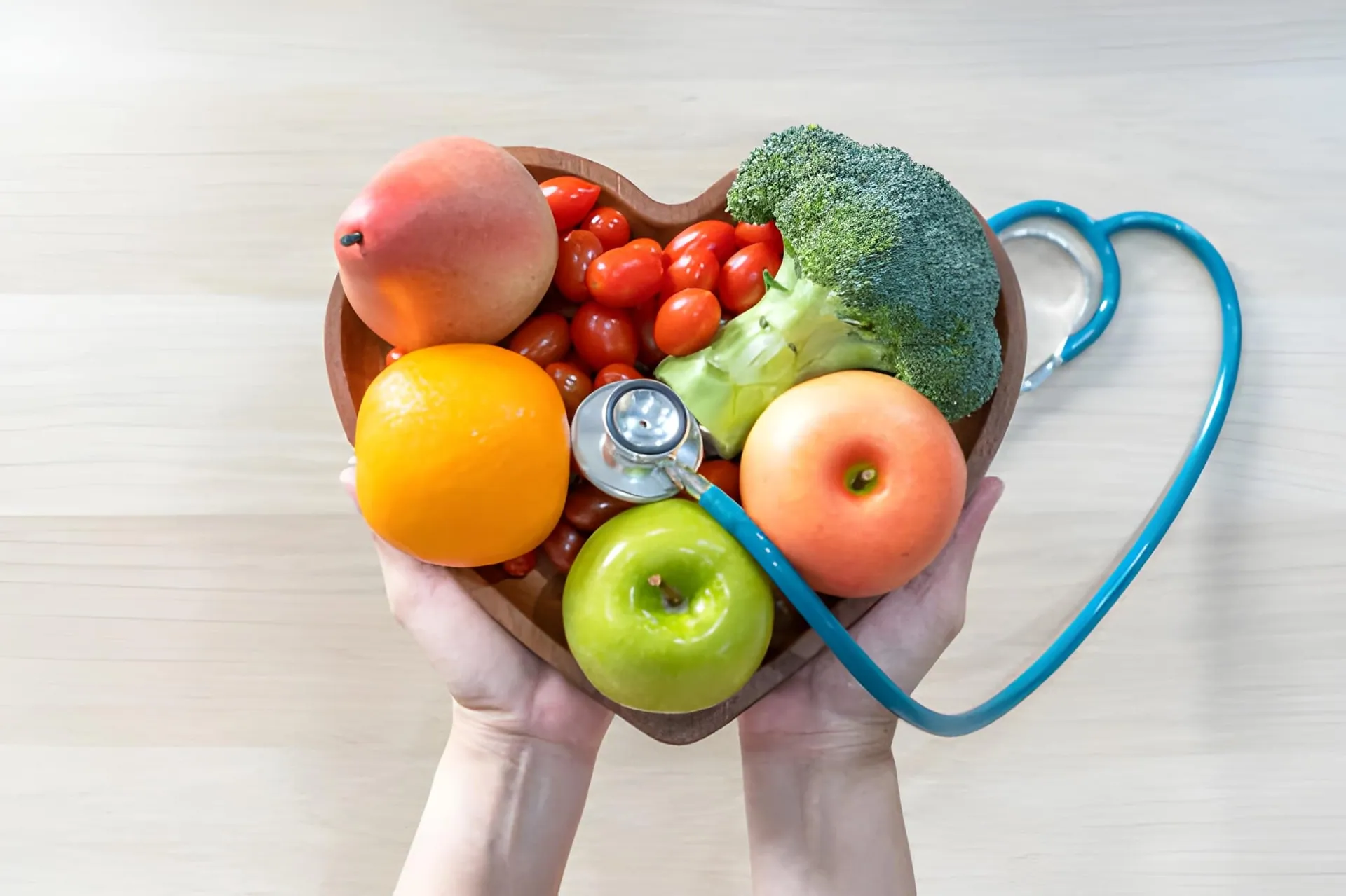 Treasure Coast weight loss healthy eating concept with heart-shaped bowl of fruits and stethoscope