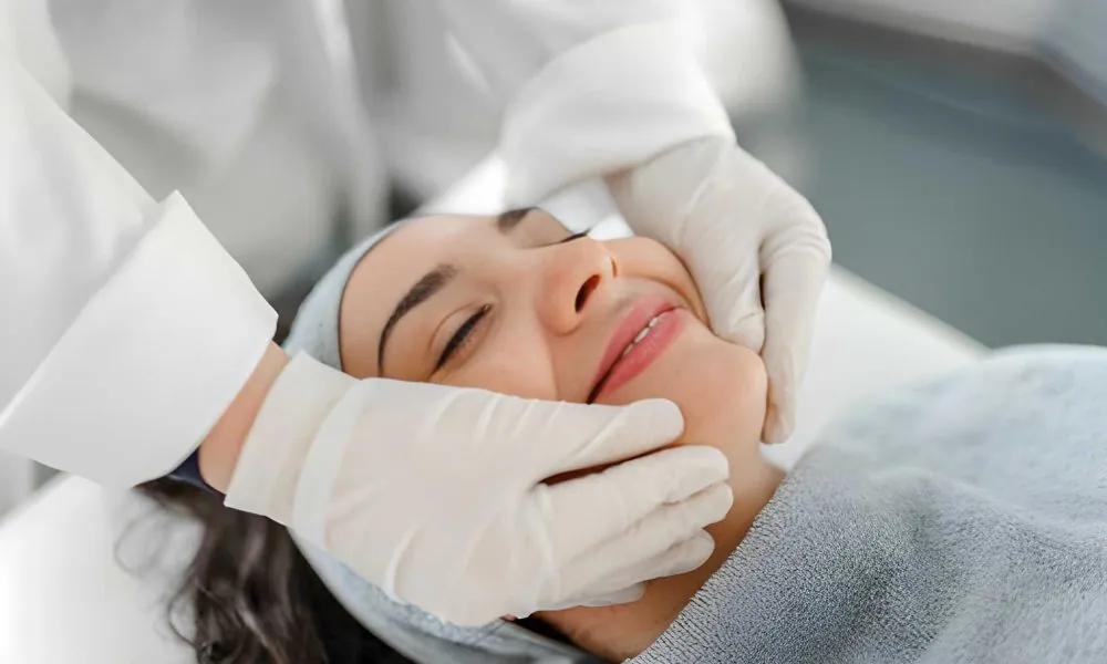 Skincare professional performing facial—Laser and aesthetics wellness treatment in clinical spa setting